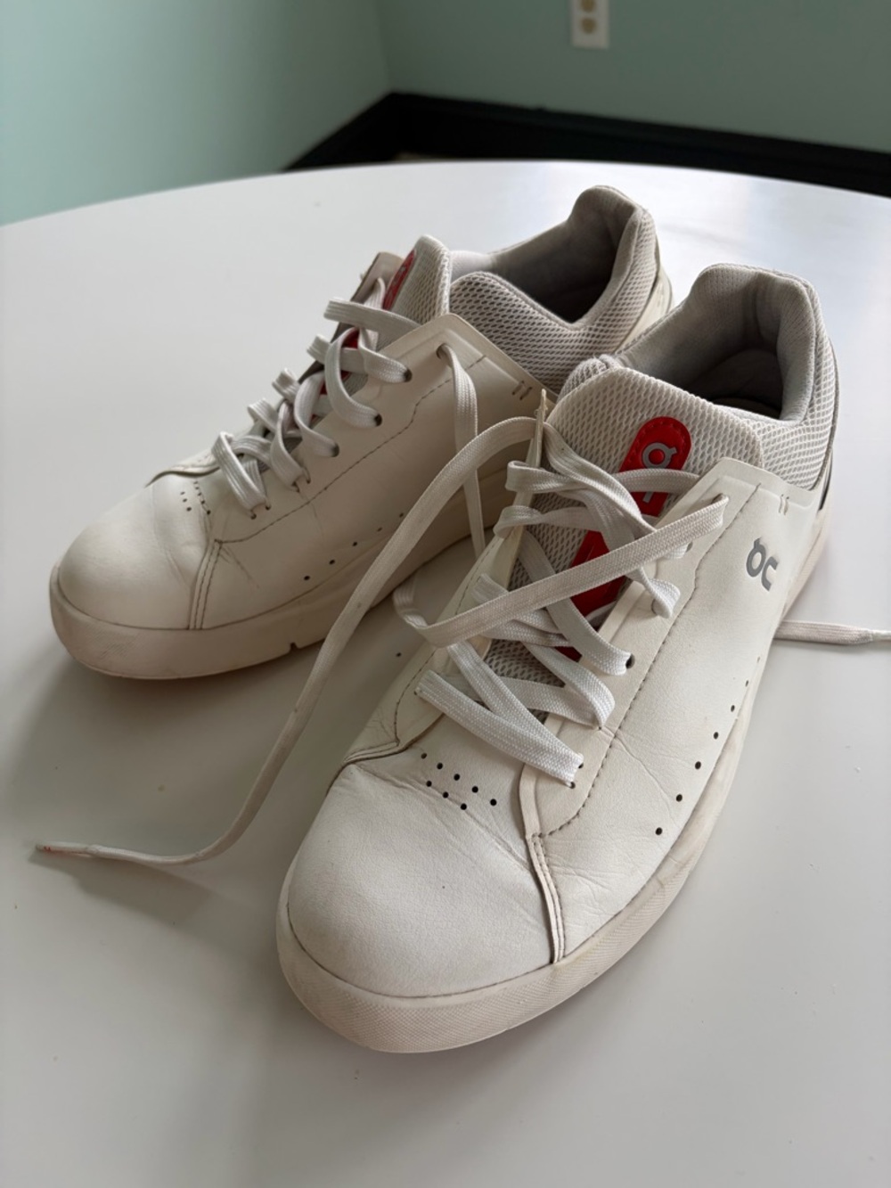 On Running White Sneakers with Red Tongue Accent
